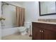 Bathroom with tub, toilet, and dark brown vanity at 5807 Garden Lakes Fern # 5807, Bradenton, FL 34203
