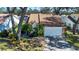 Cute single-story home with a large driveway and mature landscaping at 5807 Garden Lakes Fern # 5807, Bradenton, FL 34203