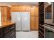 Kitchen features a large refrigerator, ample cabinetry, and a walk-in pantry at 5807 Garden Lakes Fern # 5807, Bradenton, FL 34203