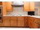 Modern kitchen features wood cabinets, stainless steel appliances, and a tile backsplash at 5807 Garden Lakes Fern # 5807, Bradenton, FL 34203