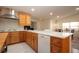 Spacious kitchen with wood cabinets, large island, and stainless steel appliances at 5807 Garden Lakes Fern # 5807, Bradenton, FL 34203