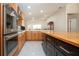 Bright kitchen with double oven, wood cabinets, and an island with butcher block top at 5807 Garden Lakes Fern # 5807, Bradenton, FL 34203