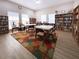Community library with tables, chairs, and ample bookshelves at 5807 Garden Lakes Fern # 5807, Bradenton, FL 34203