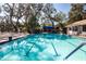 Inviting community pool surrounded by lush landscaping at 5807 Garden Lakes Fern # 5807, Bradenton, FL 34203