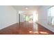 Spacious living room with wood floors and sliding glass doors leading to a screened porch at 5807 Garden Lakes Fern # 5807, Bradenton, FL 34203