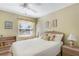 Bedroom with a window, queen bed, and neutral walls. Bookshelf and nightstand included at 5903 Canal Dr # I24, Bradenton, FL 34207
