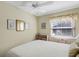 Bright bedroom with a ceiling fan, neutral walls, and decoratively framed artwork at 5903 Canal Dr # I24, Bradenton, FL 34207