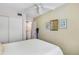 Bedroom with ceiling fan, white linens, sliding closet door, and ensuite bathroom at 5903 Canal Dr # I24, Bradenton, FL 34207