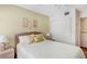 Bedroom featuring a queen bed, sliding closet doors, and decorative nightstands at 5903 Canal Dr # I24, Bradenton, FL 34207