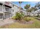 Exterior view of a white condominium complex with palm trees and patios off the rear at 5903 Canal Dr # I24, Bradenton, FL 34207