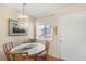 Charming dining area featuring a round table, chandelier, and natural light from the window, great for enjoying meals at 5903 Canal Dr # I24, Bradenton, FL 34207