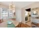 Dining area featuring a chandelier, adjacent kitchen view, and hardwood floors at 5903 Canal Dr # I24, Bradenton, FL 34207