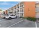 Condo exterior featuring white facade, balconies, Unit 4 signage, and convenient parking at 5903 Canal Dr # I24, Bradenton, FL 34207