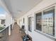 Hallway view featuring condo doors, windows, seating, and a view of the parking lot at 5903 Canal Dr # I24, Bradenton, FL 34207