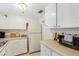 Well-organized kitchen with white cabinets, and practical appliances, perfect for preparing your favorite dishes with ease at 5903 Canal Dr # I24, Bradenton, FL 34207
