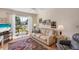 Cozy living room featuring sliding glass doors to balcony, neutral colors, and stylish rug at 5903 Canal Dr # I24, Bradenton, FL 34207