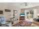 Bright living room with balcony access, ceiling fan, and comfortable seating area at 5903 Canal Dr # I24, Bradenton, FL 34207