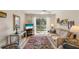 Cozy living room with balcony access, neutral sofa, and stylish rug at 5903 Canal Dr # I24, Bradenton, FL 34207