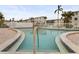Community pool featuring accessible entry, lounge chairs, and manicured landscaping at 5903 Canal Dr # I24, Bradenton, FL 34207