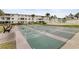 Exterior shot of shuffleboard in a condominium complex with palm trees and white buildings at 5903 Canal Dr # I24, Bradenton, FL 34207