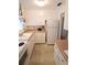 Efficient kitchen with white cabinets and appliances at 5904 17Th W St # C34, Bradenton, FL 34207