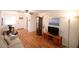 Bright living room with hardwood floors, comfy seating, and a large TV at 5904 17Th W St # C34, Bradenton, FL 34207