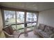 Relaxing screened balcony with seating and courtyard views at 5904 17Th W St # C34, Bradenton, FL 34207