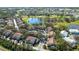 An aerial view highlights community condos nestled along a serene pond and an adjacent golf course at 6706 Fairway Gardens Dr # 6706, Bradenton, FL 34203