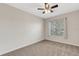 Bedroom featuring neutral carpet, a ceiling fan, and a sun-filled window at 6706 Fairway Gardens Dr # 6706, Bradenton, FL 34203