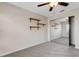 Neutral bedroom featuring mirrored closet doors, a ceiling fan, and open shelving at 6706 Fairway Gardens Dr # 6706, Bradenton, FL 34203