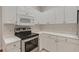 This kitchen features stainless steel appliances and white cabinetry at 6706 Fairway Gardens Dr # 6706, Bradenton, FL 34203