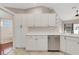 White cabinets, stainless dishwasher, and tile floors in an eat-in kitchen at 6706 Fairway Gardens Dr # 6706, Bradenton, FL 34203