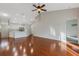 Open-concept floor plan with wood floors connects the living area to the kitchen at 6706 Fairway Gardens Dr # 6706, Bradenton, FL 34203