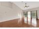 Living room area features hardwood floors, ceiling fan, and sliding glass doors at 6706 Fairway Gardens Dr # 6706, Bradenton, FL 34203