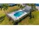 Aerial view of a sparkling community pool with lounge chairs, surrounded by lush greenery at 6706 Fairway Gardens Dr # 6706, Bradenton, FL 34203