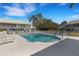 Community swimming pool with plenty of lounge chairs and lush landscaping at 6706 Fairway Gardens Dr # 6706, Bradenton, FL 34203