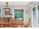 Bright dining room with hardwood floors, wooden table and chairs, and view to the back yard at 6939 Corral Gate Ln, Sarasota, FL 34241