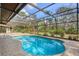 Large kidney shaped pool with screened enclosure and pavers at 6939 Corral Gate Ln, Sarasota, FL 34241