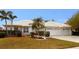 Single-story home with tile roof, two-car garage, and landscaped yard at 7212 Southgate Ct, Sarasota, FL 34243