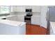 U-shaped kitchen with stainless steel appliances and white cabinetry at 7212 Southgate Ct, Sarasota, FL 34243