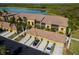 Aerial view of condo community showcasing building exterior, landscaping, and parking at 7315 River Hammock Dr # 206, Bradenton, FL 34212
