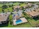 Aerial view of community with pool, lush landscaping, and golf course at 7315 River Hammock Dr # 206, Bradenton, FL 34212