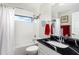 Modern bathroom with a black countertop and white fixtures at 7315 River Hammock Dr # 206, Bradenton, FL 34212