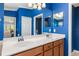 Bathroom with double vanity and a view into bedroom at 7315 River Hammock Dr # 206, Bradenton, FL 34212