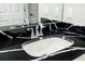 Bathroom with black countertop, white sink and bathtub at 7315 River Hammock Dr # 206, Bradenton, FL 34212