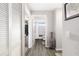 Hallway with view into a bathroom and laundry area at 7315 River Hammock Dr # 206, Bradenton, FL 34212