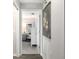 Bright hallway with access to bedroom and decorative wall art at 7315 River Hammock Dr # 206, Bradenton, FL 34212