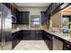 Community kitchen with dark wood cabinets and granite countertops at 7315 River Hammock Dr # 206, Bradenton, FL 34212