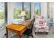 Bright home office features a wooden desk and floral armchair at 7315 River Hammock Dr # 206, Bradenton, FL 34212