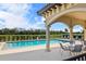 Community pool with a covered patio and seating area at 7315 River Hammock Dr # 206, Bradenton, FL 34212